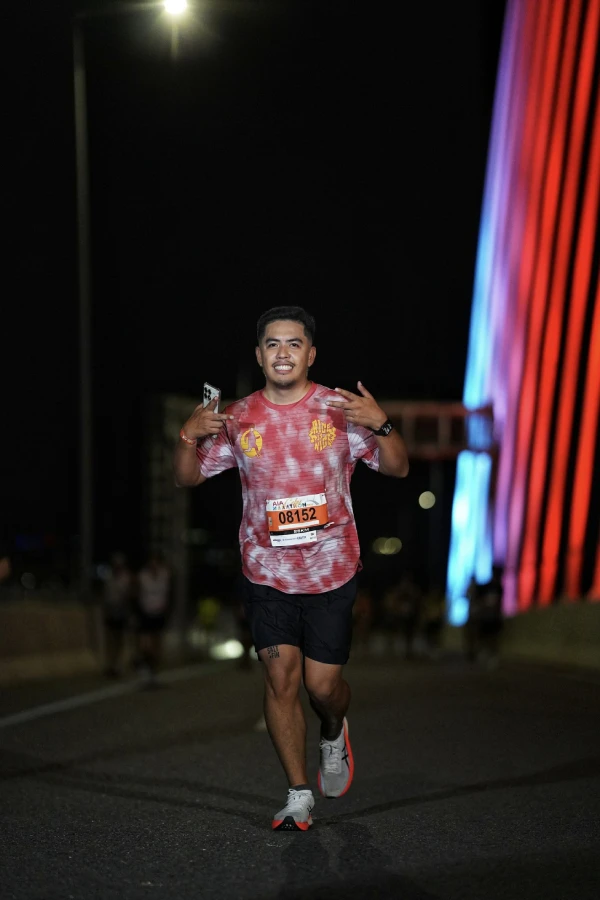 A man running at night in the street.